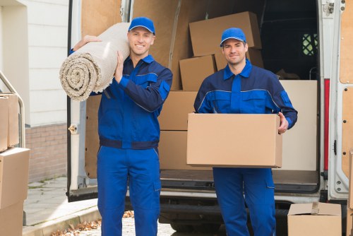 Local movers loading furniture into a removal van