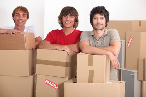 Staff assessing moving route and handling furniture carefully during a relocation