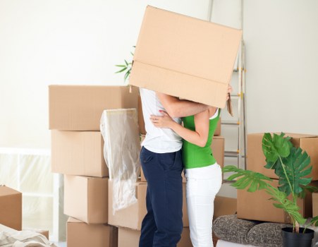 Professional mover loading furniture into a van in West London